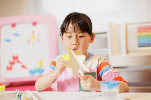 istock young girl making craft at home 2081224123