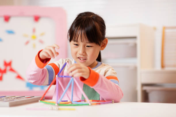 istock young girl playing Construction toys at home 2081224128