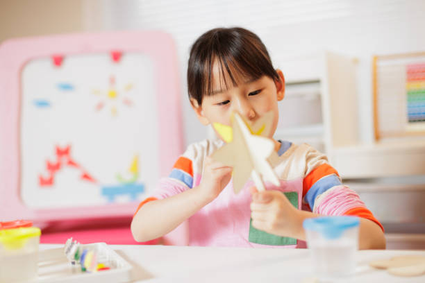 istock young girl making craft at home 2081224133