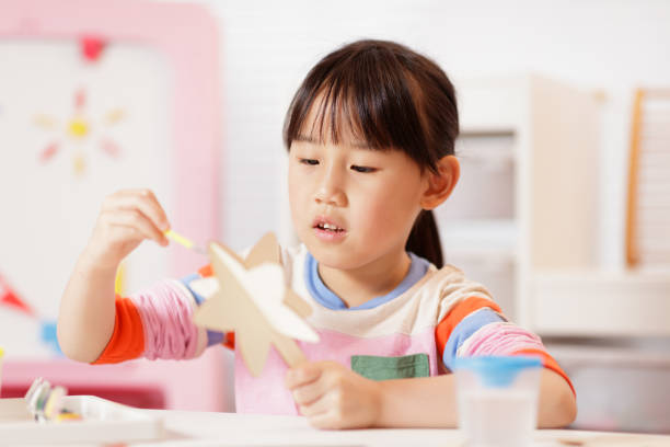 istock young girl making craft at home 2081224692