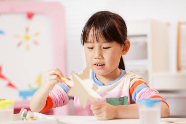 istock young girl making craft at home 2081224693