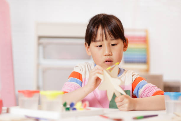 istock young girl making craft at home 2081224697