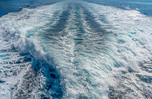 Churning water surface at the back side of a motor boat