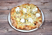 italian Pizza whit four cheeses called quattro formaggi in a plate isolated on wooden background