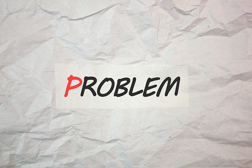 PROBLEM text, writing on crumpled paper. Problem word, concept.