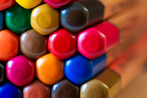Color image depicting a close up macro abstract view of a collection of colored pencils.