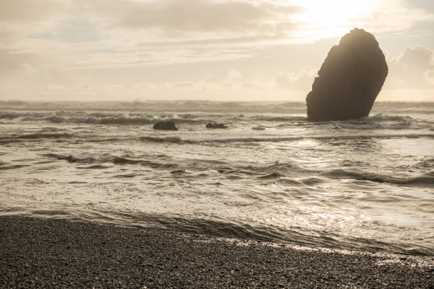 istock A rocky shoreline with a large rock in the water 2081279598