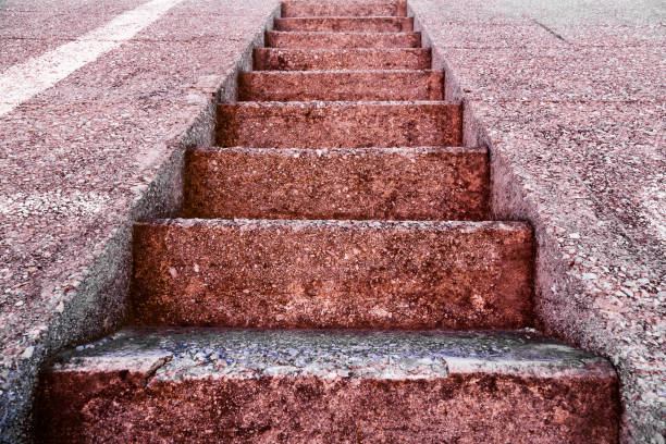 Monolithic staircase made of marble chips leading up.