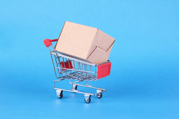 istock Shopping cart with paper box isolated on blue background 2081294623