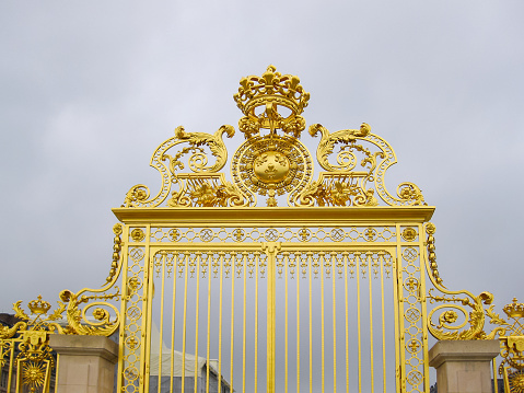 Paris, France - April 2016: Golden gate of Versailles palace, Paris suburbs