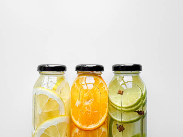 istock Lemon, orange, and lime detox drinks in glass bottles on white background with copy space. Concept for design and print. 2081320166