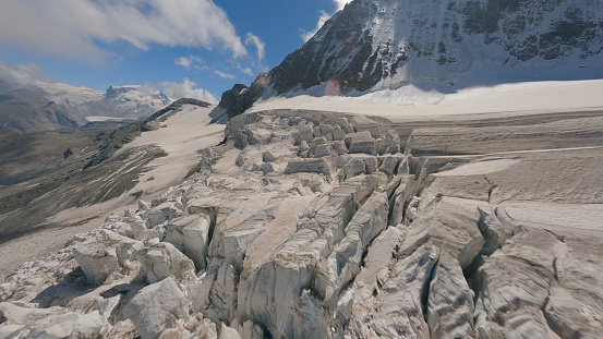 Aerial view of crevasse field on glacier leading to mountains, Swiss Alps