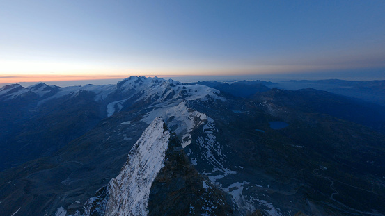 Aerial view of snowy mountain peaks at sunset, Swiss Alps