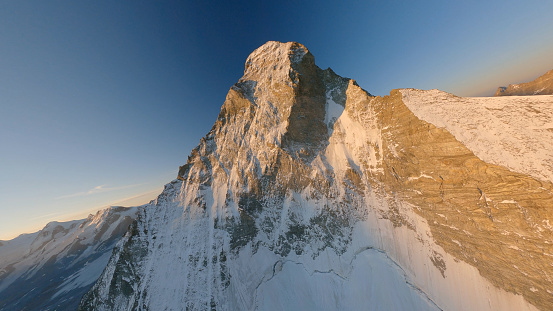Aerial view of snowy mountain peaks at sunset, Swiss Alps