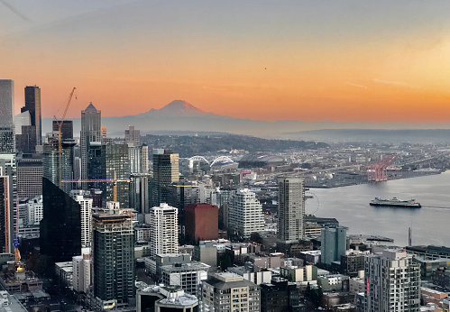 Aerial view of city skyline, bay and mountain at sunrise, Seattle