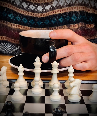 Detail of woman playing chess at cafe