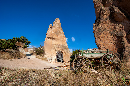 Üzümlü Church and horse carriage carved into the fairy chimney in Göreme Kızılçukur valley
