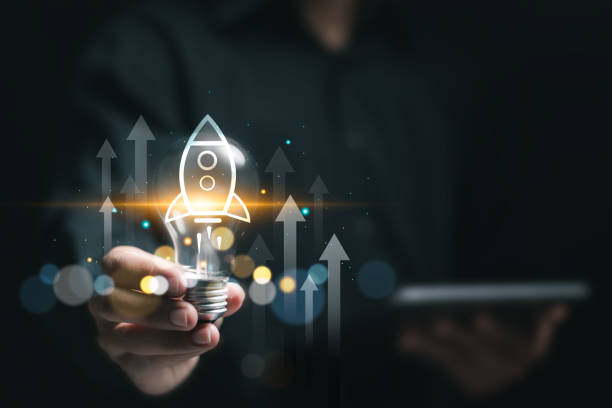 istock Businessman holding light bulb with virtual rocket icon and up arrow for fast start up business. Strategic planning and business success. Startup business concept. 2081333008
