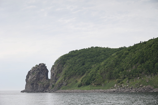 Coast of Shiretoko Peninsula, a World Natural Heritage site. Spring afternoon on the coastline by the Sea of Okhotsk in Shari District.