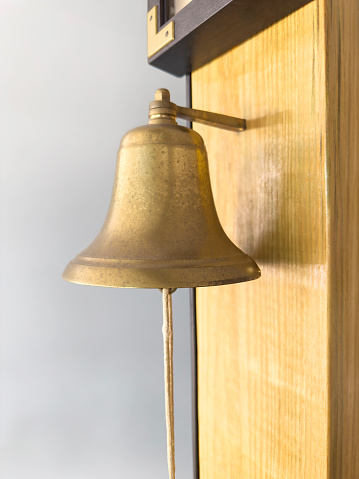 Brass bell on a wall in a house