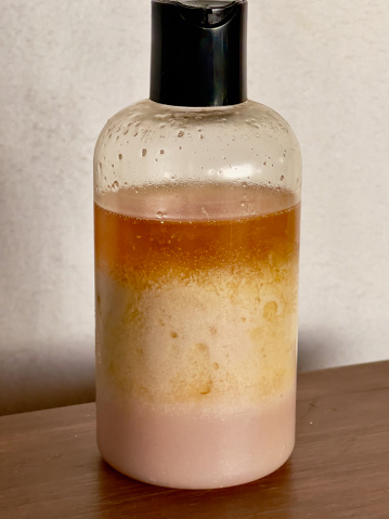 Old separated body lotion in clear container