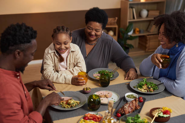 Happy Black Senior Woman Enjoying Dinner with Family