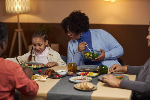 istock Mother Talking To Girl Using Smartphone at Dinner Table 2081375894