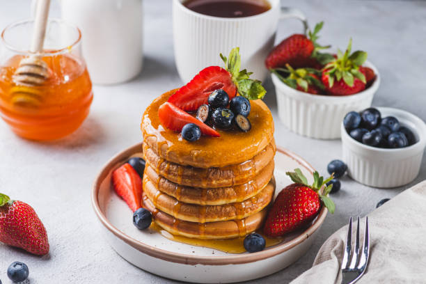 istock Pancakes with honey and berries on a plate 2081384604