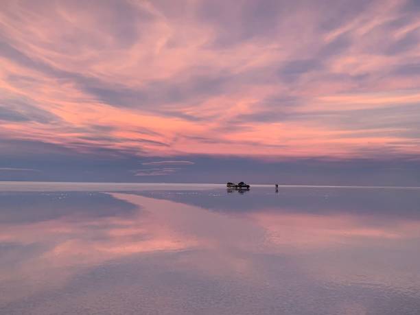 istock Sunset pink surreal sky clouds above lake water 2081394299