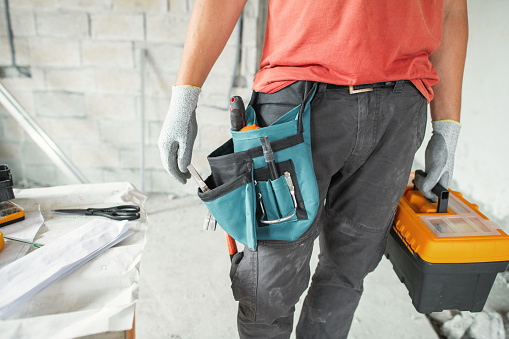 Worker at a construction site during an apartment or a house reconstruction, renovation or repair