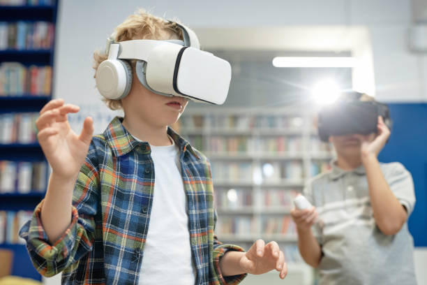 istock Blonde Boy Wearing VR Headset in Library 2081435479