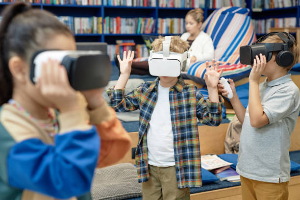 istock Kids Wearing VR Headsets in Library 2081435482