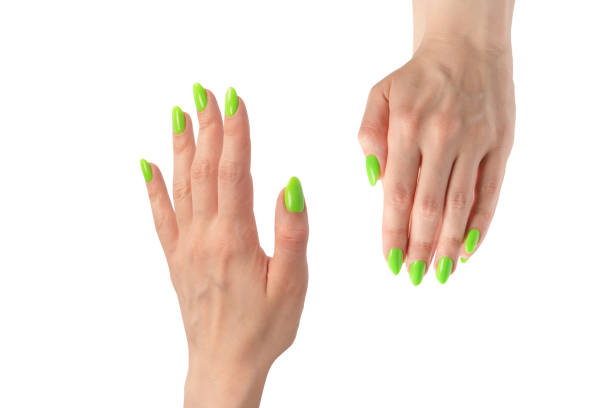 istock Hand of a woman with green naols hold some tiny or thin object. 2081450651