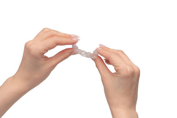 istock Transparent mouth guard in a woman's hand isolated. 2081451235