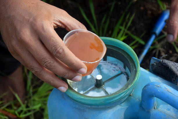 istock a farmer pouring herbicides and chemical into container 2081463845