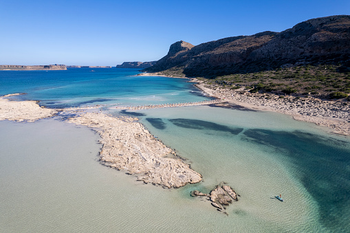 Aerial view of woman stand up paddle boarding on lagoon, Balos Lagoon, Crete