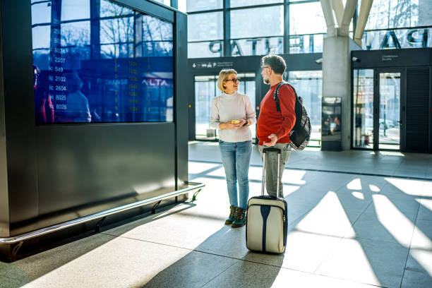 istock Couple in front of an information board at a train station 2081474546