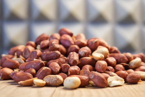 Heap of roasted peanuts, side view. Peanuts close up. Nuts. Peanuts peeled and fried.