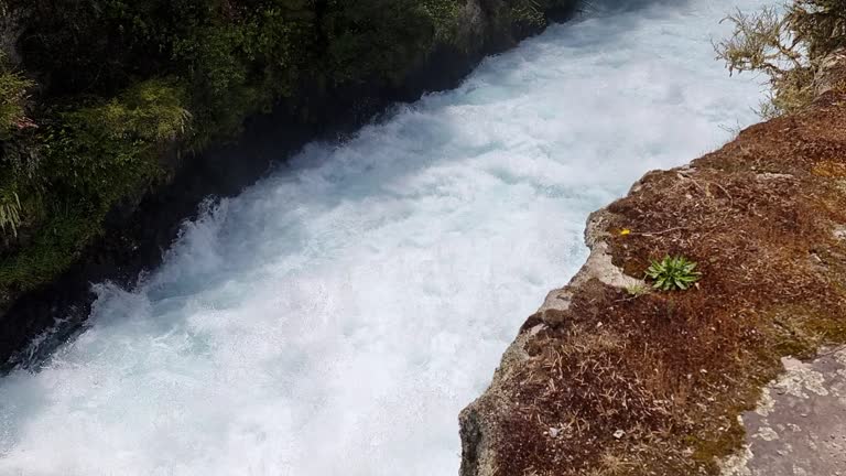 looking down on the turbulent water inside a canyon of the Huka Falls in New Zealand