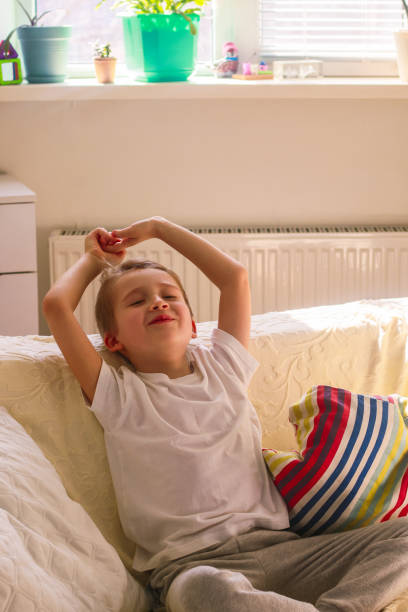 istock boy sitting on the sofa in a bright room 2081521471