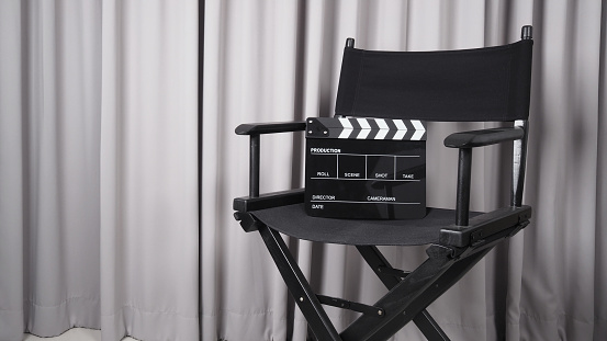 Clapper board or movie slate with black director chair use in video production , movie, cinema industry.