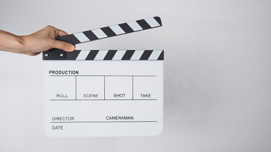 Clapper board or movie slate with hands use in video production , movie, cinema industry.