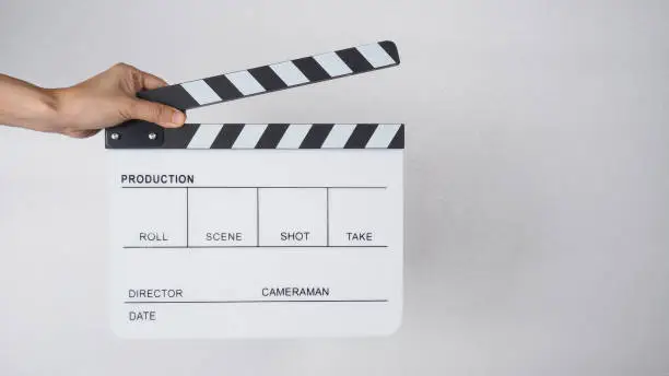 Photo of Clapper board or movie slate with hands use in video production , movie, cinema industry.