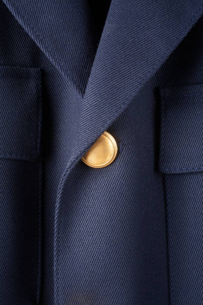 Detail of elegant jacket with golden button.