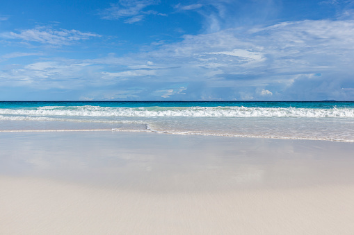 white sand beach and horizon over water, indian ocean.