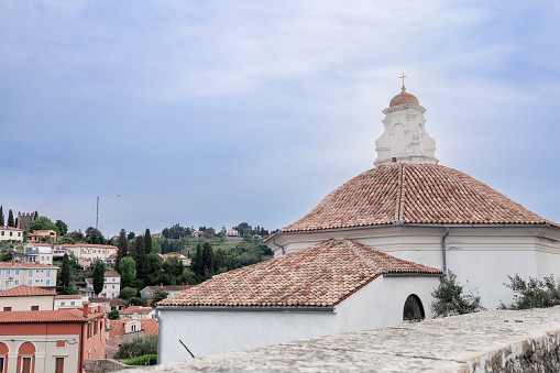 octagonal roof of the Baptistery of St. George's Cathedral in Piran, Slovenia against a cloudy sky