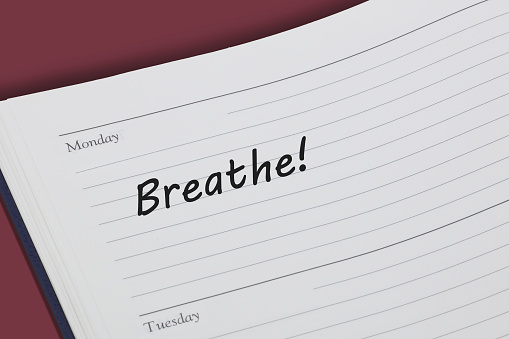 A Breathe reminder message in an open diary