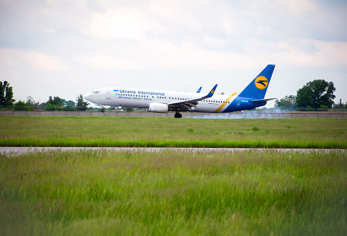 Passenger plane on the airport runway. Ukrainian Airlines UIA aircraft UR-PSQ Boeing 737. Ukraine, Kyiv -28 May 2021.