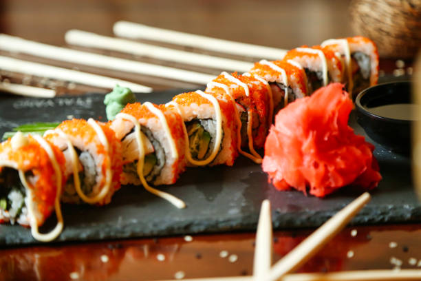 istock Close Up of Sushi Roll With Chopsticks 2081575678