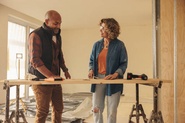 istock Collaborative home renovation project: Diy couple discussing remodeling plans with mature carpenters 2081581661